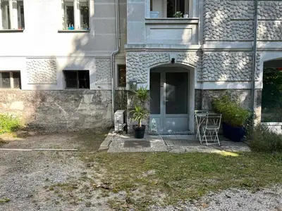 a building with a door and a table in front of it at Charming appartment 3-min walk to old town - FREE PARKING in Ljubljana