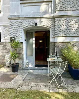 a table and a chair in front of a building at Charming appartment 3-min walk to old town - FREE PARKING in Ljubljana