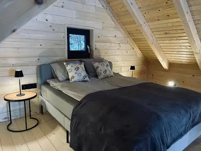 a bedroom with a bed in a wooden cabin at Radovna Chalet with Panoramic View in Mojstrana