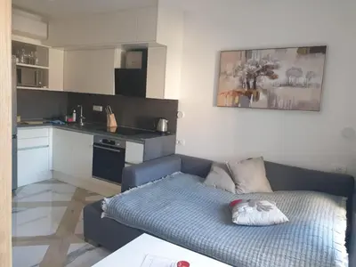 a living room with a couch and a kitchen at PALAR Apartment in Ljubljana