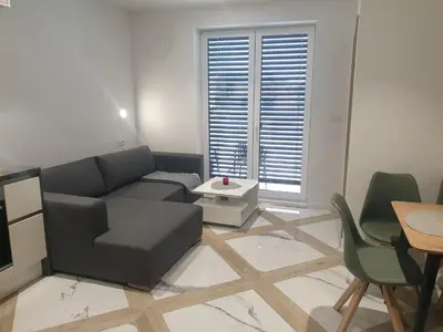 a living room with a couch and a table at PALAR Apartment in Ljubljana