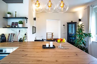 a kitchen with a wooden counter top in a room at Pipa’s Place - Stylish garden prime location apt in Ljubljana
