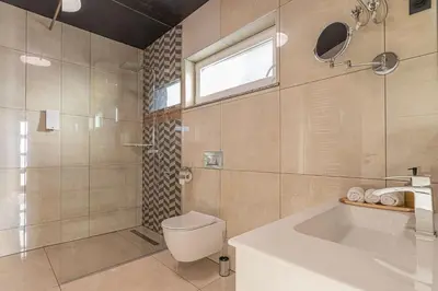 a bathroom with a toilet and a shower and a sink at Wellness Resort Trebnje in Trebnje