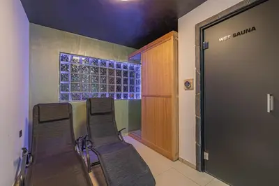 a group of chairs in a room with a door at Wellness Resort Trebnje in Trebnje