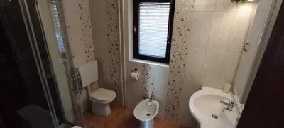 a bathroom with a toilet and a sink and a shower at Idyllic Retreat Next to an Elven Forest in Gozd Martuljek