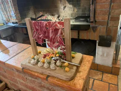 a wooden cutting board with fruit on top of a counter at Idyllic Retreat Next to an Elven Forest in Gozd Martuljek