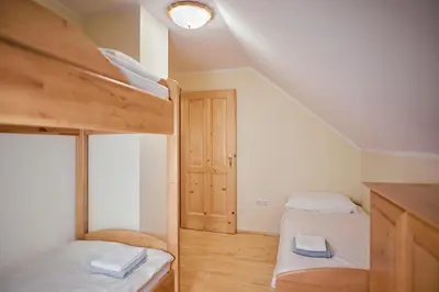 a small room with two bunk beds and a door at Apartma Smučišče Krvavec in Cerklje na Gorenjskem