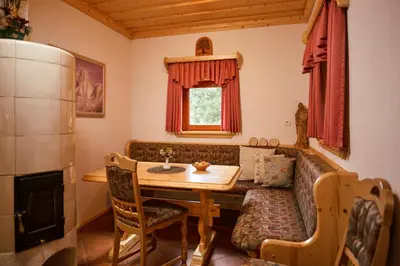 a living room with a table and a couch at Apartma Smučišče Krvavec in Cerklje na Gorenjskem