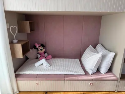 a toy bed with a stuffed animal and pillows at Penthouse Apartment - Garden Residence in Ljubljana