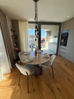 a dining room with a table and chairs and a window at Penthouse Apartment - Garden Residence in Ljubljana