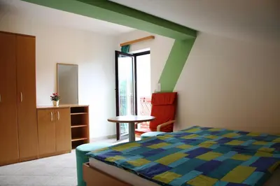 a bedroom with a bed and a table and a window at Apartment Kolman in Tolmin