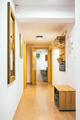 a hallway with a bathroom and a sink in a room at Apartment House VINARIA in Zgornja Ložnica