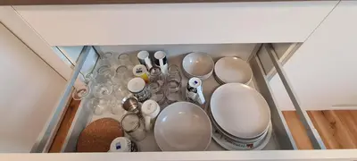 a bunch of dishes and utensils in a cabinet at Little Plaza City Centre in Ljubljana