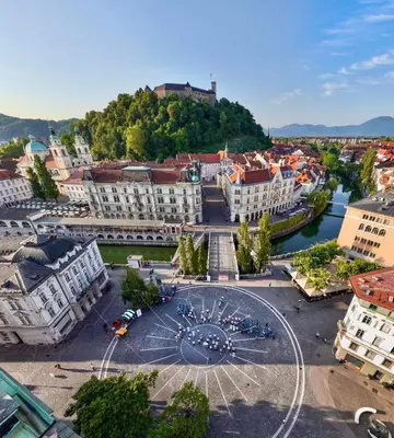 an aerial view of a city with a clock in the middle at Little Plaza City Centre in Ljubljana
