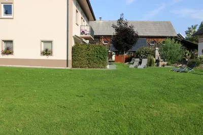 a house with a yard with green grass at Viktoria Apartments in Bled