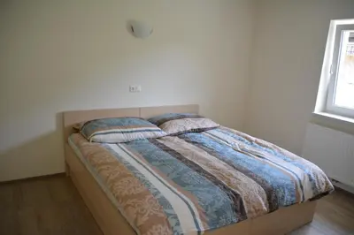 a bed with two pillows on it in a bedroom at Viktoria Apartments in Bled