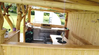 an outside view of a kitchen in a wooden house at Viktoria Apartments in Bled