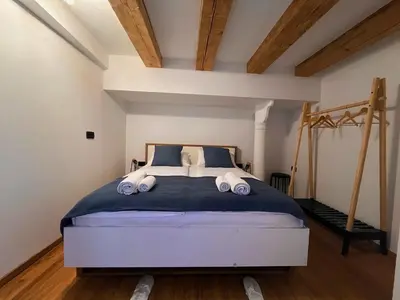 a bedroom with a large bed with towels on it at Apartman LA CASA 77B in Ljubljana