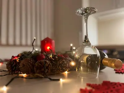 a table with a wine glass and a candle holder at Apartman LA CASA 77A in Ljubljana