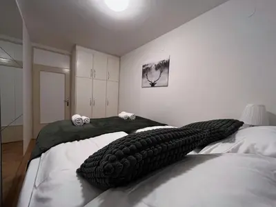 a bedroom with two beds with tire pillows on them at Apartman LA CASA 77A in Ljubljana