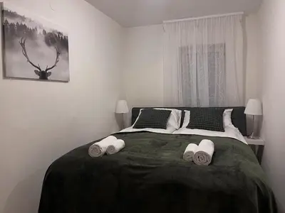 a bedroom with a bed with two towels on it at Apartman LA CASA 77A in Ljubljana