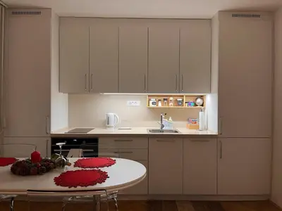a small kitchen with a table and a sink at Apartman LA CASA 77A in Ljubljana