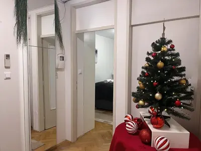 a christmas tree on a table in a room at Apartman LA CASA 77A in Ljubljana