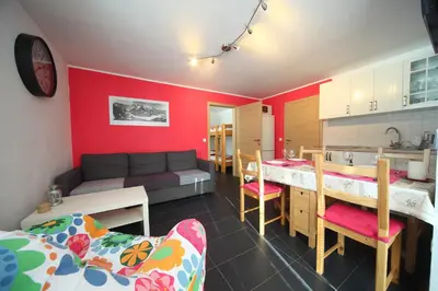 a room with a kitchen and a living room at Apartment Leposa in Kranjska Gora