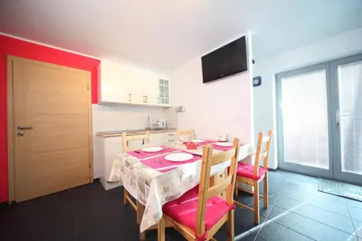 a kitchen and dining room with a table and chairs at Apartment Leposa in Kranjska Gora