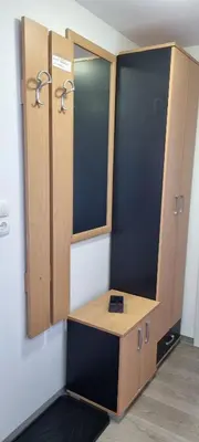 a dressing room with wooden cabinets and a mirror at Time4you in Čatež ob Savi
