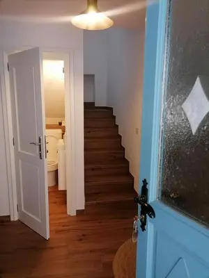 a hallway with a staircase leading to a bathroom at Lukova hiša- Luka's house in Vipava