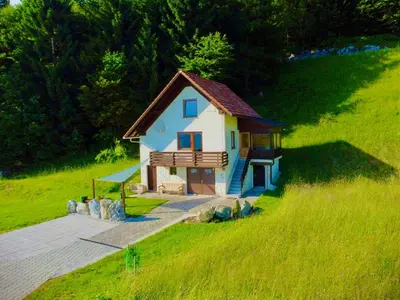 a small house on the side of a hill at Apartma Bine in Cerkno