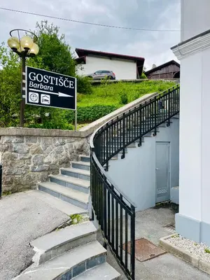 a set of stairs with a sign next to a house at Gostišče Barbara in Idrija