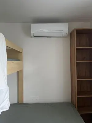 a bedroom with a bed with a air conditioner at Apartma Dreamscape in Radovljica