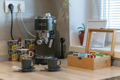 a coffee maker and two cups on a table at Old Town's Legend: City center condo with balcony in Maribor