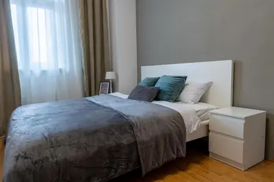 a bedroom with a bed with two pillows on it at Old Town's Legend: City center condo with balcony in Maribor