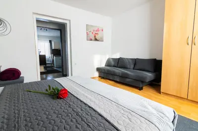 a bedroom with a bed with a red rose on it at Apartma Ella in Lovrenc na Pohorju