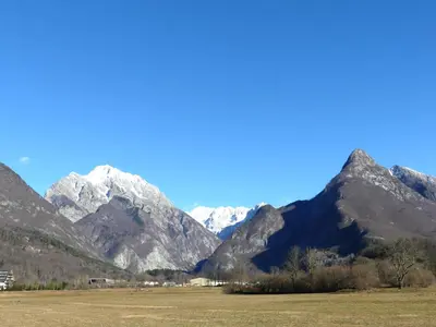 a mountain range with snow capped mountains in the background at Happy nes.t in Bovec