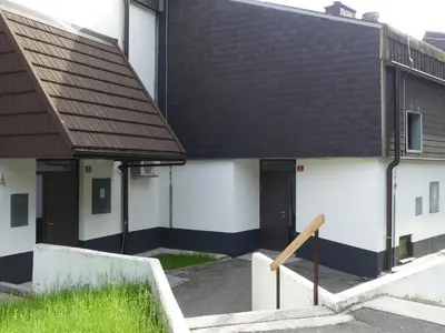 a building with a black roof and white walls at Happy nes.t in Bovec