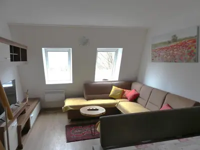 a living room with a couch and a table at Happy nes.t in Bovec