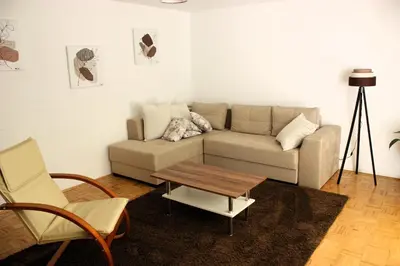 a living room with a couch and a coffee table at Apartment Jona, Bled in Bled