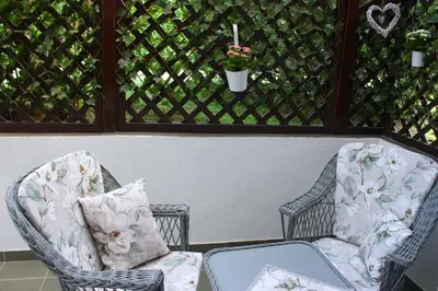 two chairs sitting on a porch with a window at Apartment Jona, Bled in Bled