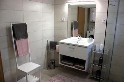 a bathroom with a sink and a mirror at Apartment Jona, Bled in Bled