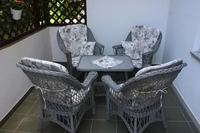 a table and chairs on a balcony with a table at Apartment Jona, Bled in Bled