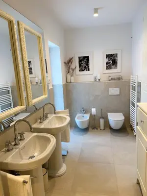 a bathroom with two sinks and two toilets at Ca' S Lorenz - A Luxury 100m2 Apartment in a Chic Vineyard Villa in Dobrovo