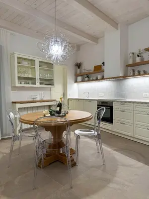 a kitchen with a table and chairs and a chandelier at Ca' S Lorenz - A Luxury 100m2 Apartment in a Chic Vineyard Villa in Dobrovo