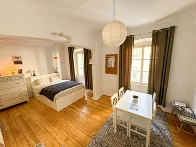 a bedroom with a bed and a table in it at The North Apartment in Ljubljana