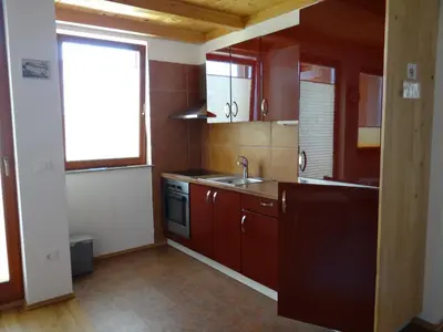 a small kitchen with a sink and a window at Apartments Trebušak in Laze v Tuhinju