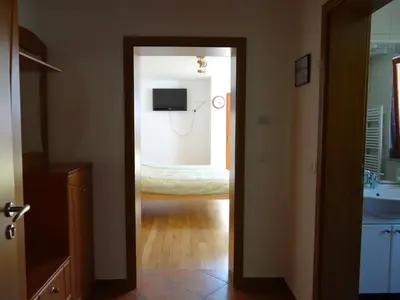 a door leading into a bedroom with a bed at Apartments Trebušak in Laze v Tuhinju