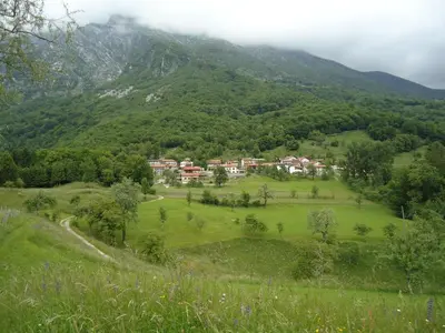 a small village in a valley in the mountains at Apartment Šavli in Kobarid